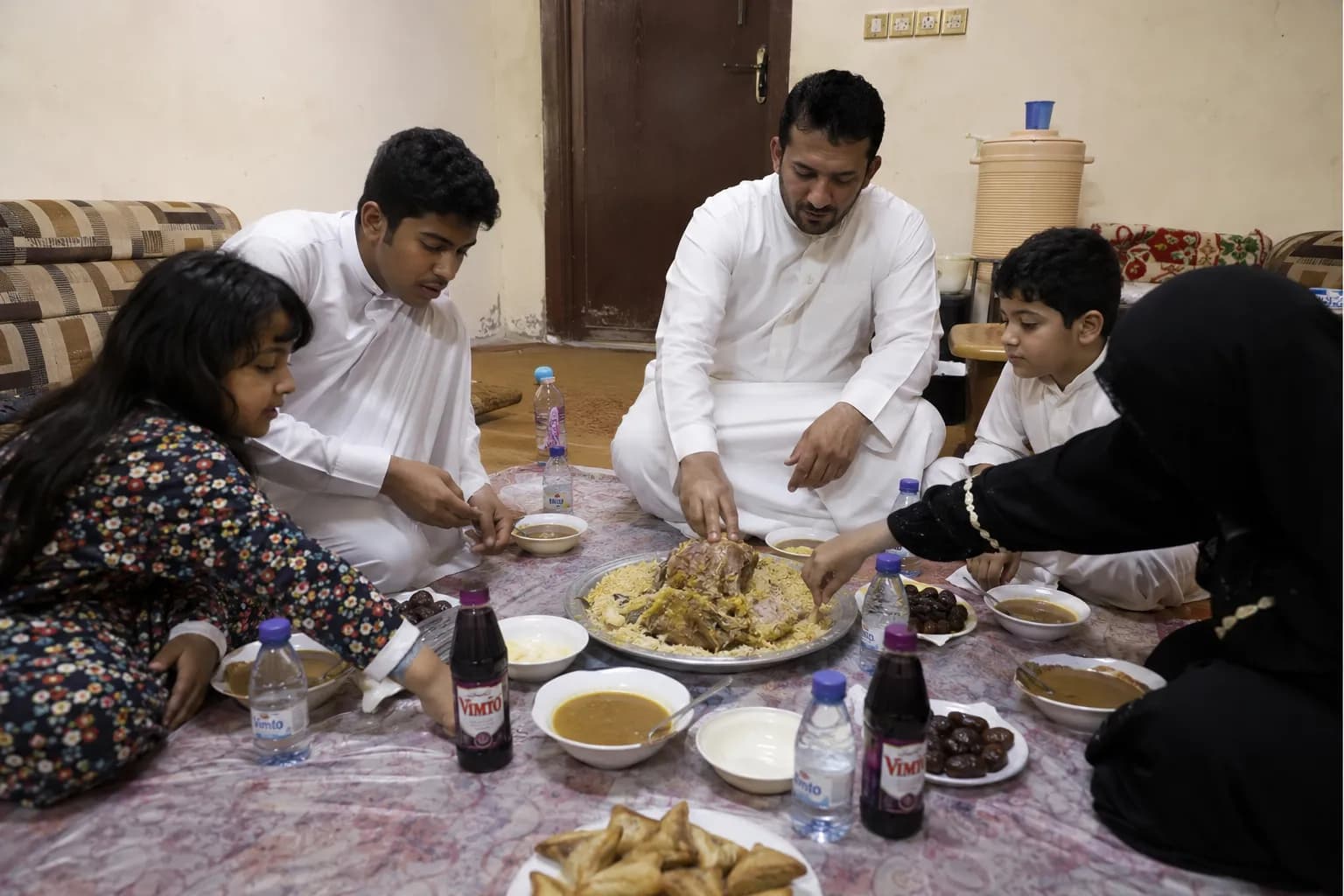 Saudi family sharing a traditional iftar meal during Ramadan