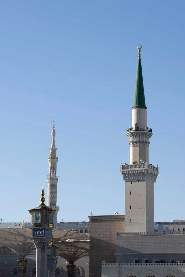 Minarets of Al-Masjid an-Nabawi in Medina under clear blue sky